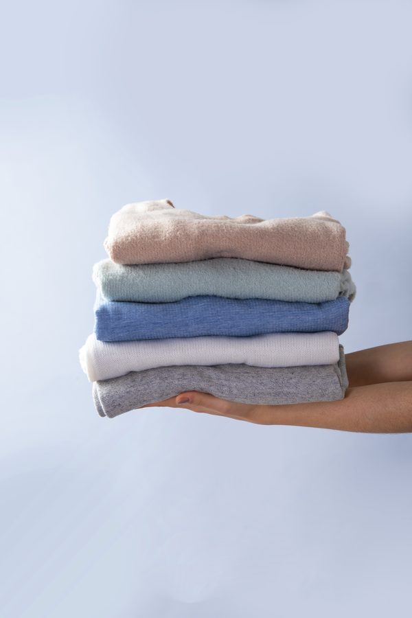 Freshly laundered clothes, neatly folded and ready for delivery